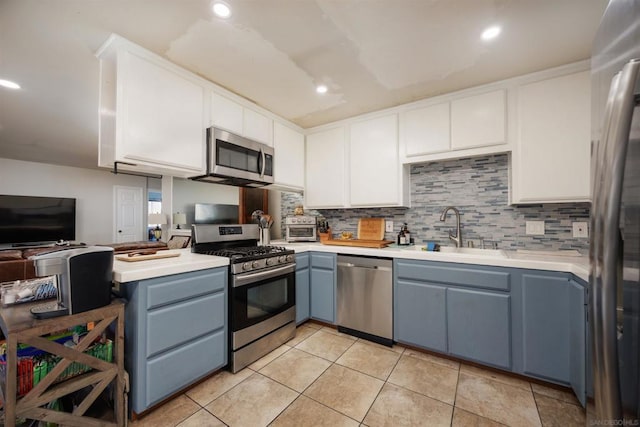 kitchen featuring white cabinetry, sink, tasteful backsplash, and appliances with stainless steel finishes