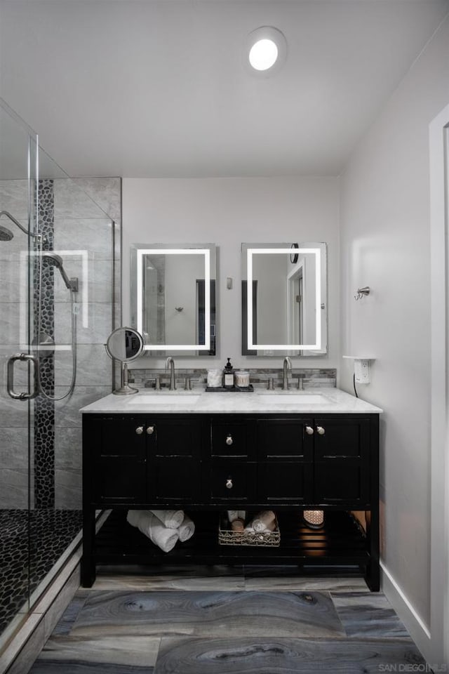 bathroom featuring vanity and an enclosed shower