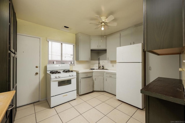 kitchen with ceiling fan, sink, light tile patterned flooring, and white appliances