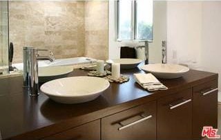 bathroom featuring vanity and a bath