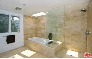 bathroom featuring shower with separate bathtub