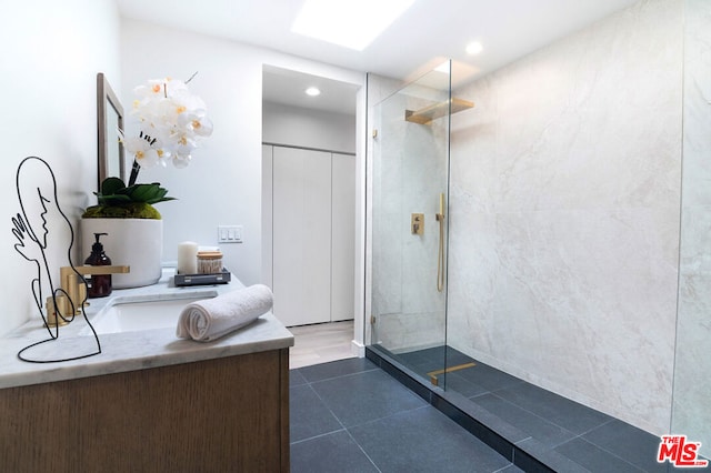 bathroom with a tile shower and tile patterned flooring