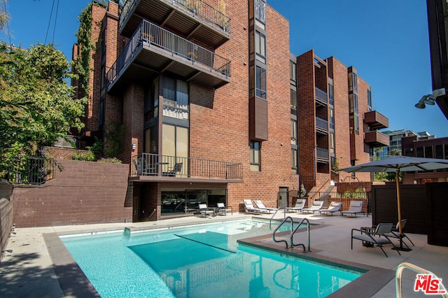 view of swimming pool with a patio area