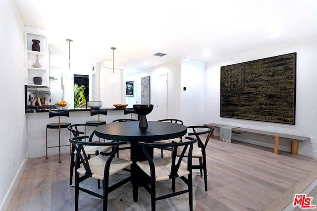 dining space featuring light wood-type flooring