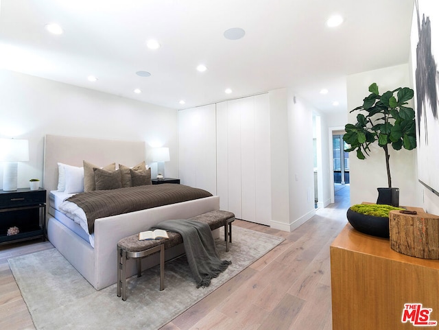 bedroom with a closet and light wood-type flooring