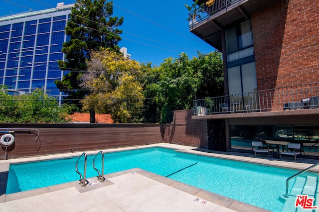 view of swimming pool featuring a patio area