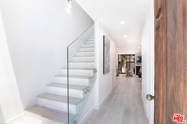 stairs with wood-type flooring