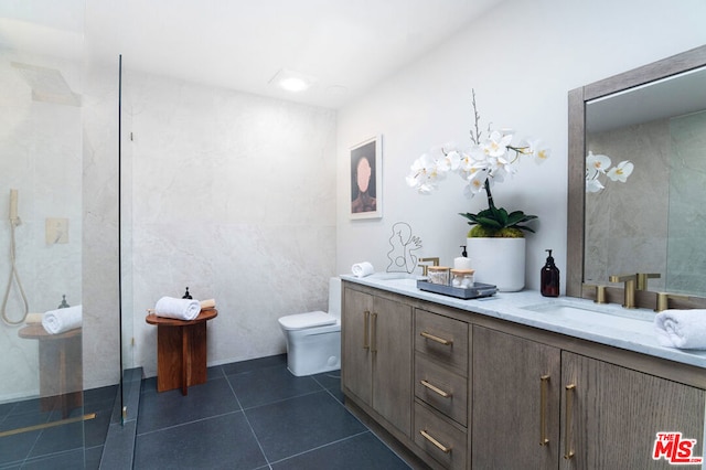 bathroom featuring vanity, tile patterned floors, and toilet