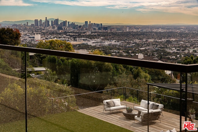 balcony at dusk featuring an outdoor living space