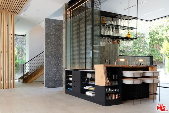 bar featuring a wealth of natural light and a wall of windows