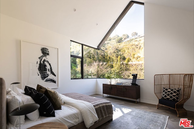 bedroom featuring lofted ceiling and hardwood / wood-style floors