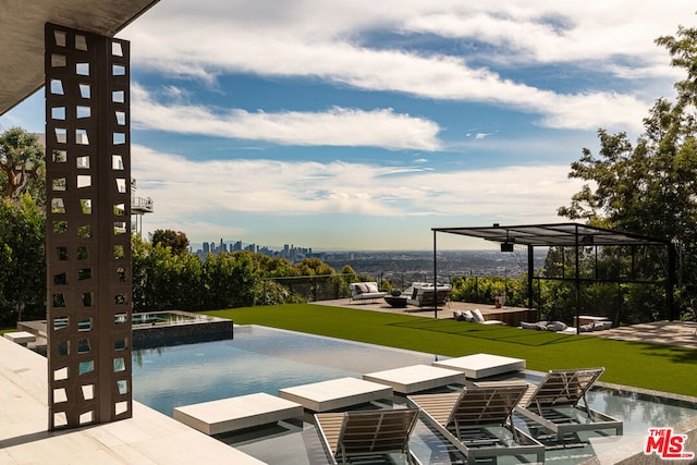 view of pool with a patio, outdoor lounge area, a yard, and an in ground hot tub