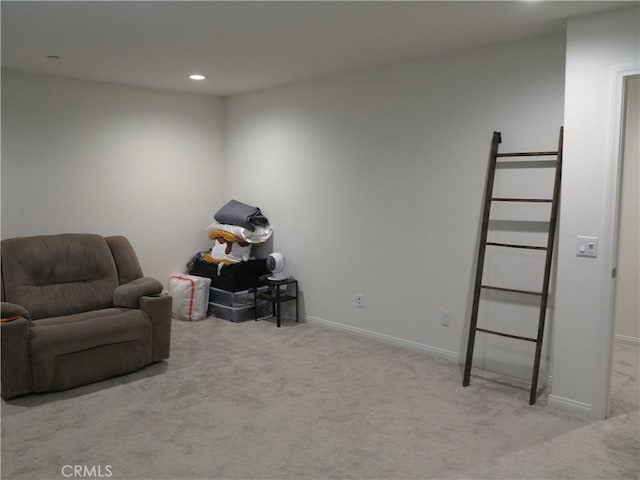 sitting room featuring light colored carpet