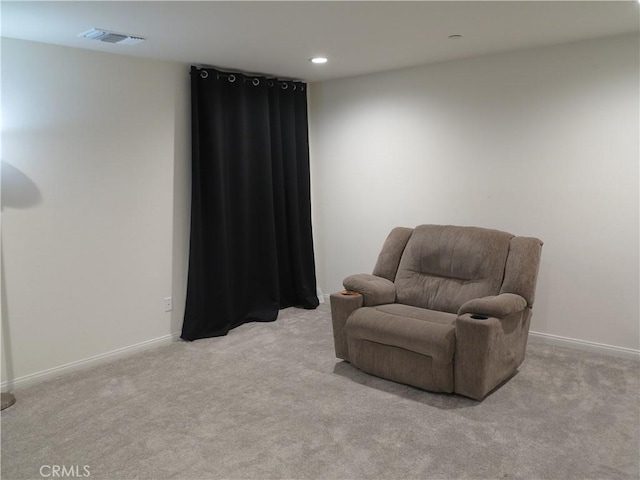 sitting room featuring light carpet