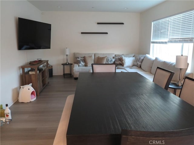 dining space with wood-type flooring