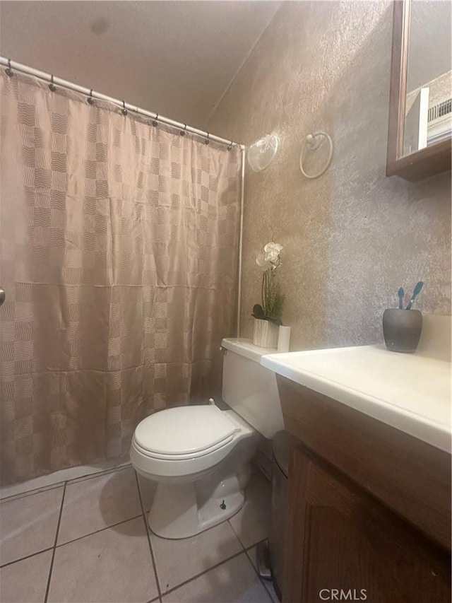 bathroom featuring tile patterned floors, toilet, and vanity