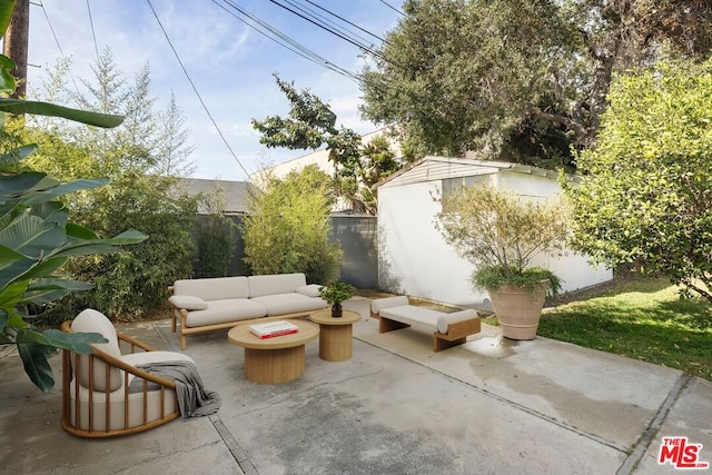 view of patio / terrace featuring an outdoor living space and a storage shed