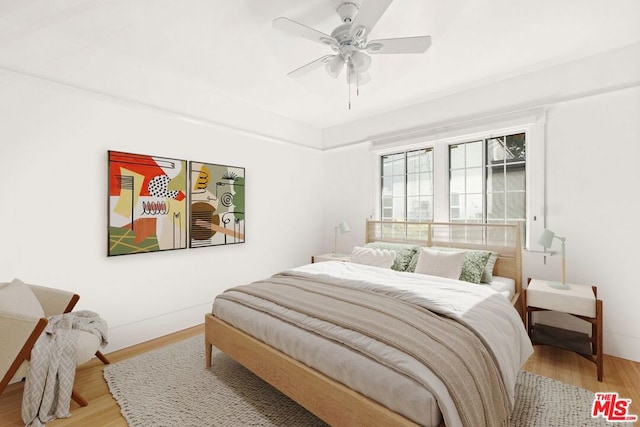 bedroom with hardwood / wood-style floors and ceiling fan