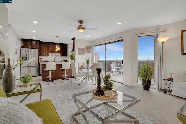 living room with ceiling fan and sink