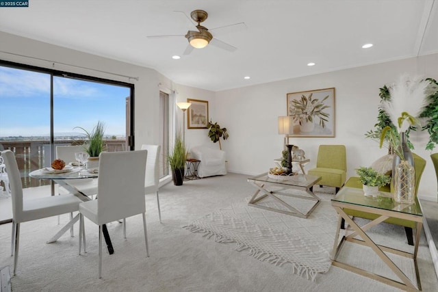 interior space featuring light colored carpet and ceiling fan