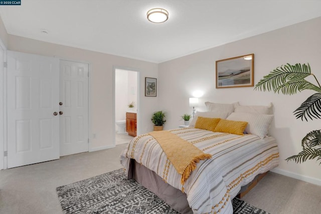 carpeted bedroom with ensuite bath