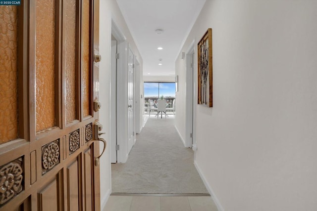 hallway featuring light carpet