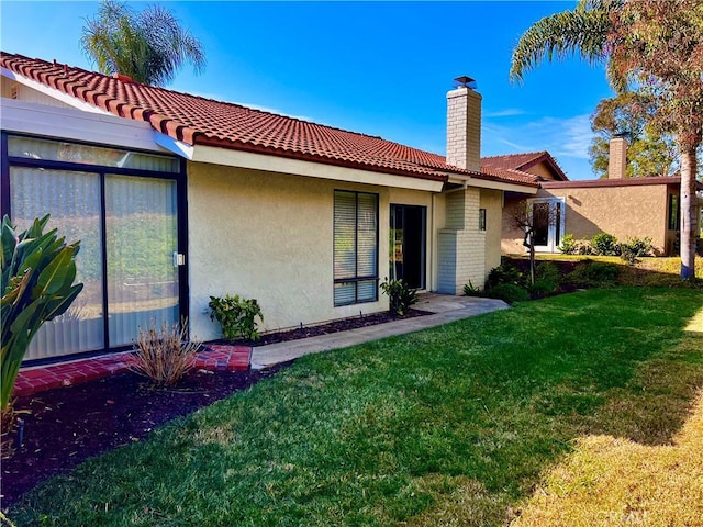 rear view of house featuring a yard