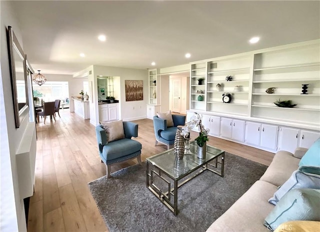 living area featuring recessed lighting, baseboards, and wood finished floors