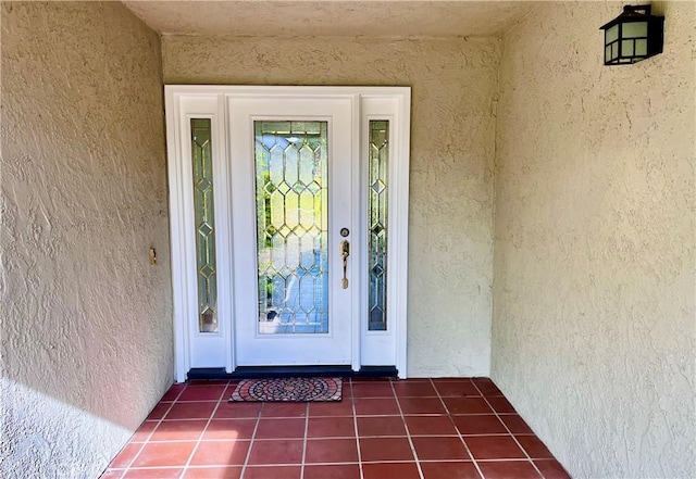 view of exterior entry with stucco siding