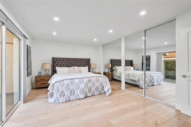 bedroom with light wood-type flooring, access to exterior, multiple closets, and recessed lighting