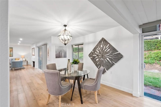 dining space with light wood-style flooring, a chandelier, baseboards, and recessed lighting