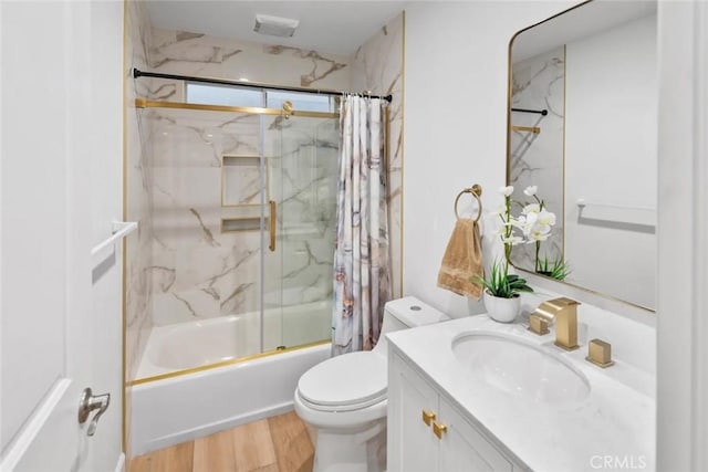 full bathroom with toilet, shower / bath combination with glass door, wood finished floors, and vanity