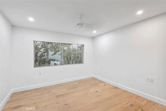 empty room with baseboards and wood finished floors