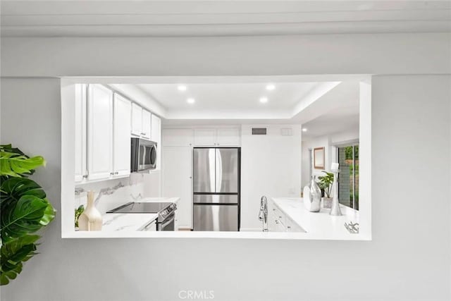 kitchen featuring appliances with stainless steel finishes, light countertops, visible vents, and recessed lighting
