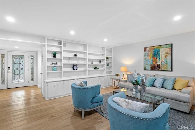 living area with recessed lighting and light wood-style floors