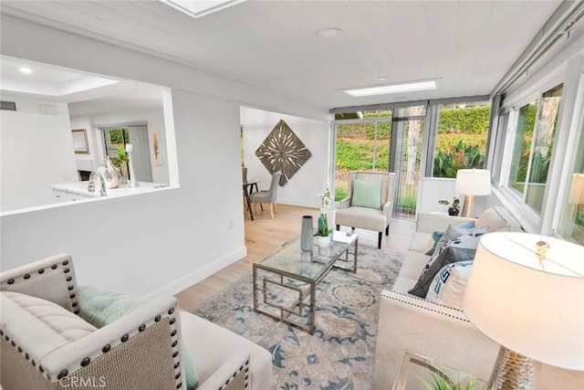 living area featuring recessed lighting, visible vents, baseboards, and wood finished floors