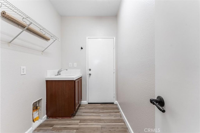 washroom featuring sink and light hardwood / wood-style floors