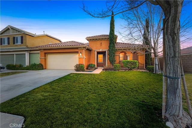 view of front of home with a yard and a garage