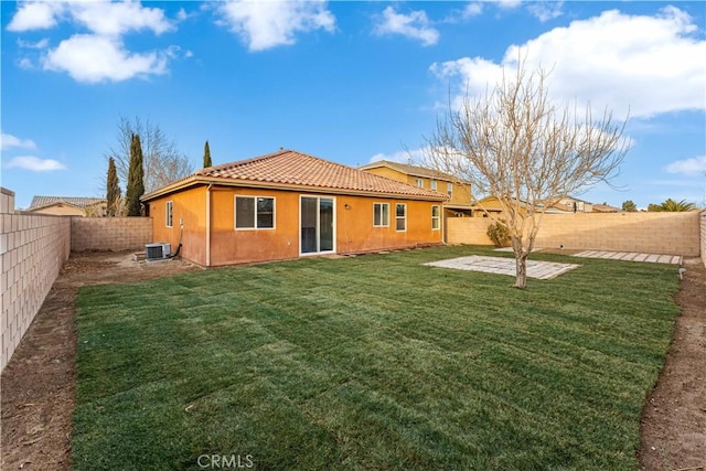 rear view of property featuring a yard, a patio area, and central air condition unit