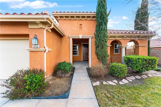 view of exterior entry featuring a garage