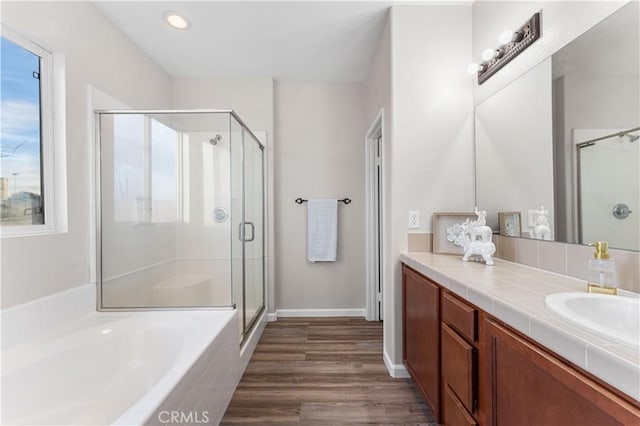 bathroom featuring vanity, separate shower and tub, plenty of natural light, and hardwood / wood-style floors