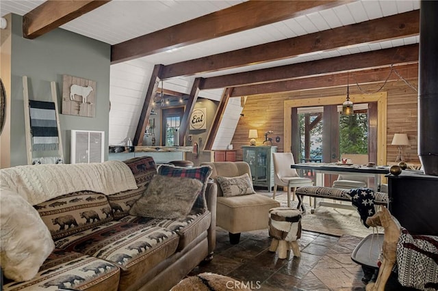 living room with wooden walls and beam ceiling