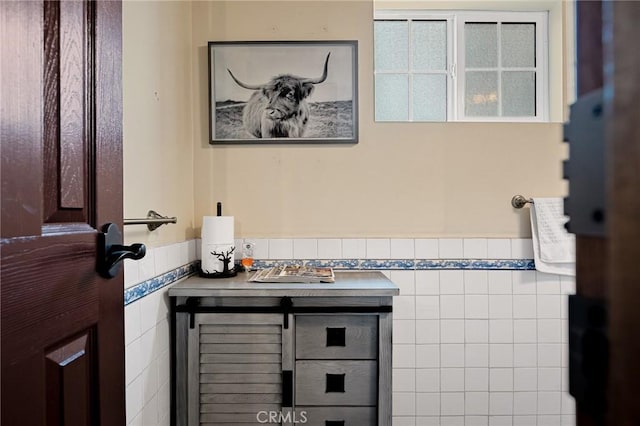 bathroom with tile walls and vanity