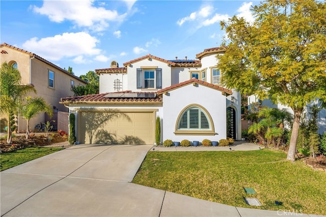 mediterranean / spanish home with a garage and a front lawn