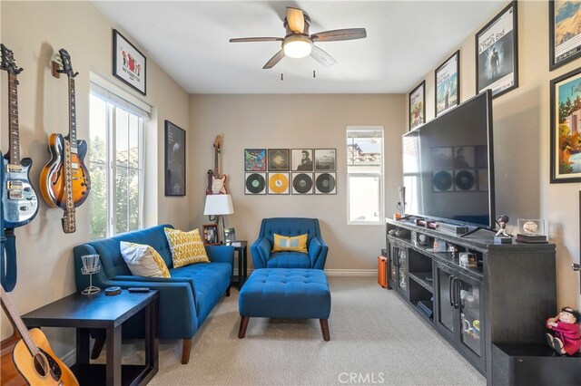 living room featuring light carpet, a wealth of natural light, and ceiling fan