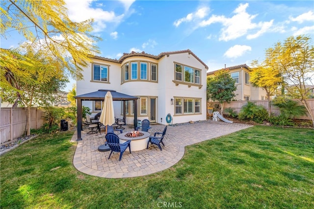 back of house with a yard, a fire pit, a patio area, and a gazebo