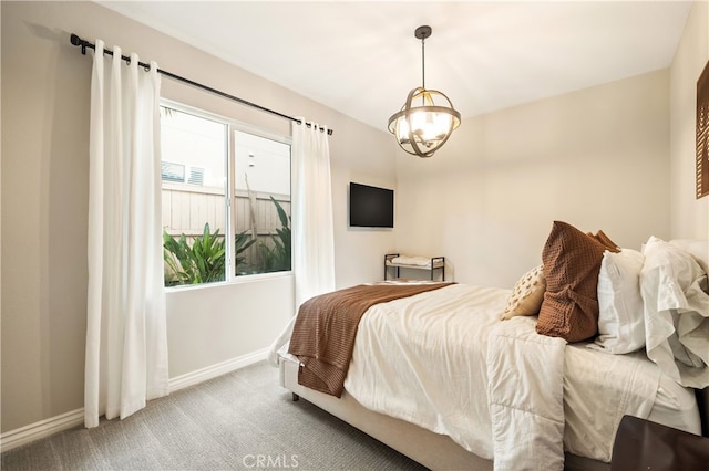 bedroom with carpet floors and a chandelier