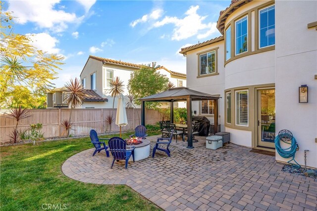 view of patio featuring a gazebo and an outdoor fire pit