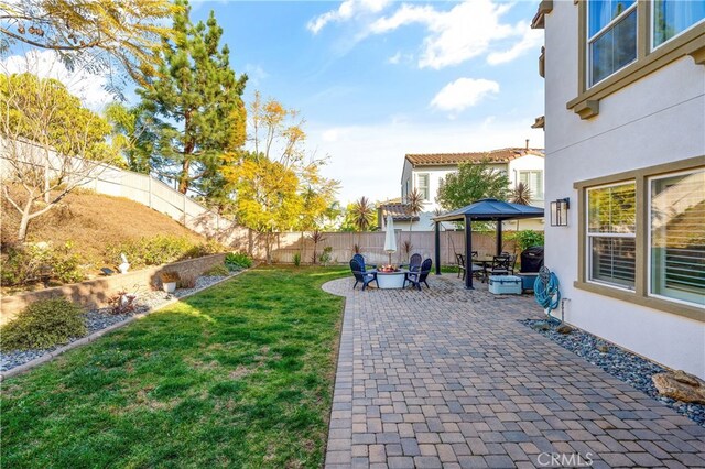 view of yard with a gazebo, a patio, and a fire pit