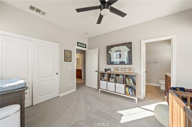 bathroom featuring ceiling fan and toilet